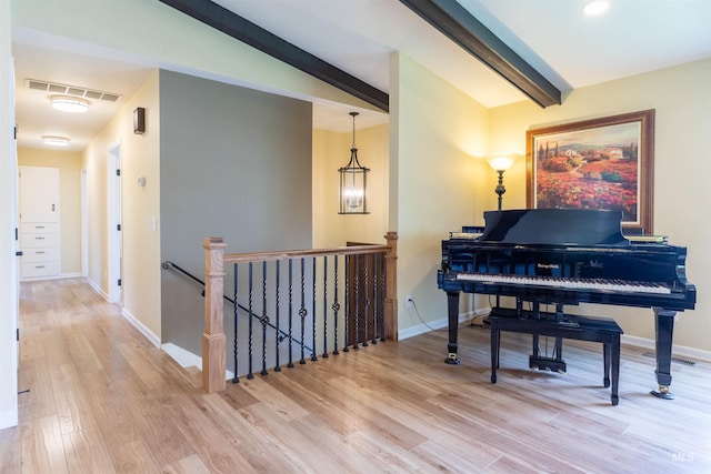 1205 Ponderosa Dr, Moscow, ID 83843 - living area featuring an upstairs landing, wood finished floors, beamed ceiling, and baseboards