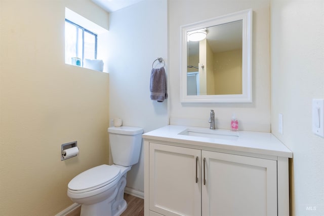 1205 Ponderosa Dr, Moscow, ID 83843 - bathroom featuring vanity, toilet, baseboards, and wood finished floors