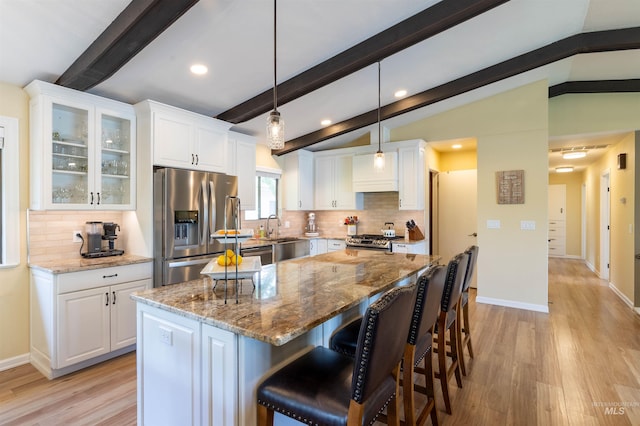 1205 Ponderosa Dr, Moscow, ID 83843 - kitchen featuring appliances with stainless steel finishes, backsplash, light wood-type flooring, white cabinets, and recessed lighting