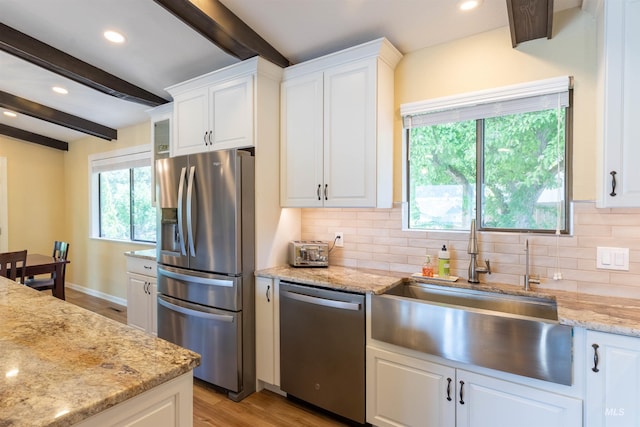 1205 Ponderosa Dr, Moscow, ID 83843 - kitchen featuring appliances with stainless steel finishes, beamed ceiling, white cabinets, decorative backsplash, and recessed lighting