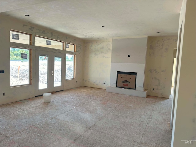 unfurnished living room featuring french doors