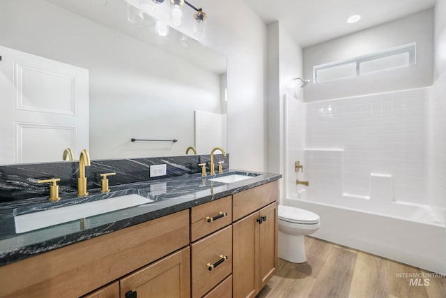 full bathroom with vanity, wood-type flooring, shower / bathtub combination, and toilet