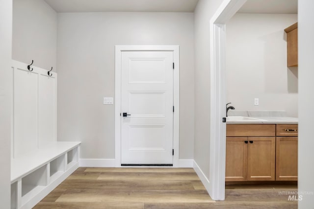 mudroom featuring sink and light hardwood / wood-style floors