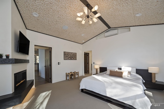 carpeted bedroom featuring a glass covered fireplace, a notable chandelier, baseboards, and vaulted ceiling