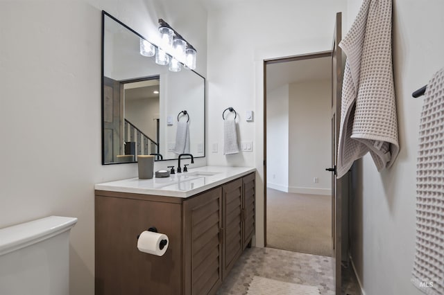 bathroom with toilet and vanity