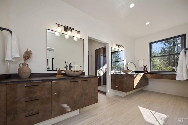bathroom featuring recessed lighting, vanity, and wood finished floors