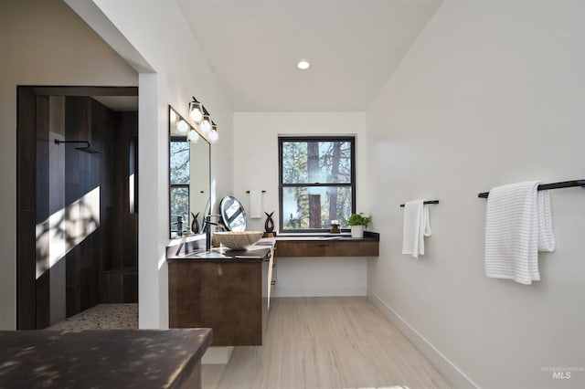 full bath featuring a walk in shower, recessed lighting, vanity, and baseboards