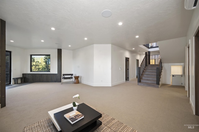 interior space with recessed lighting, light carpet, and a textured ceiling