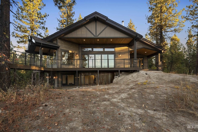 back of property featuring a wooden deck