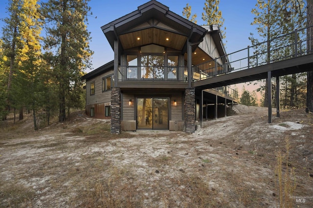 back of property featuring a deck
