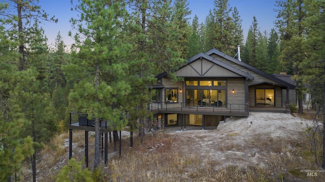 rear view of house with a view of trees