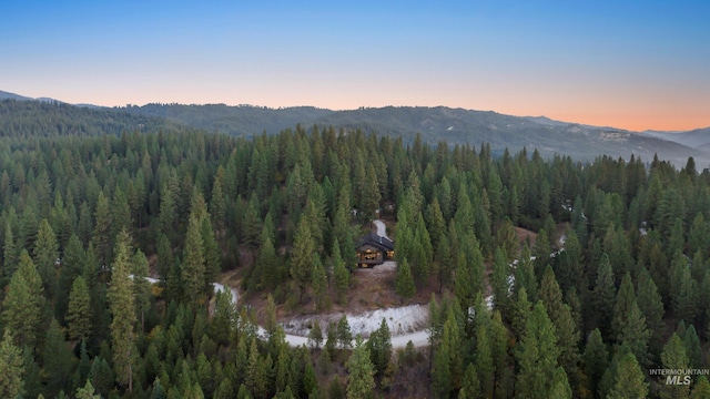 aerial view with a view of trees and a water and mountain view