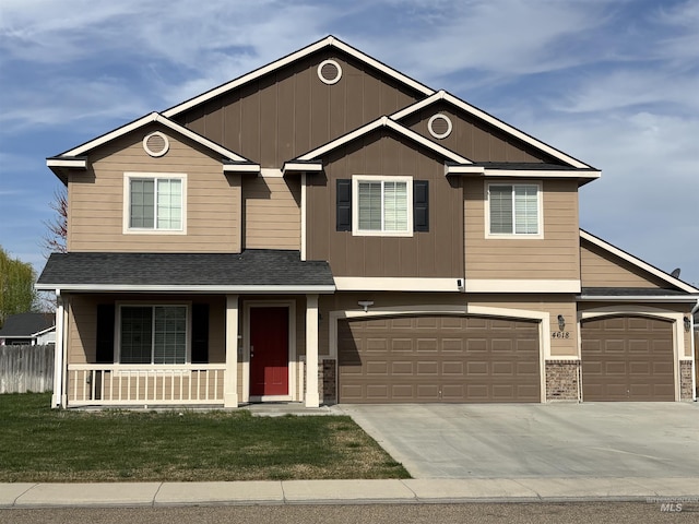 4618 Braeburn, Caldwell, ID 83607 - view of front of home with a front yard, an attached garage, covered porch, board and batten siding, and driveway