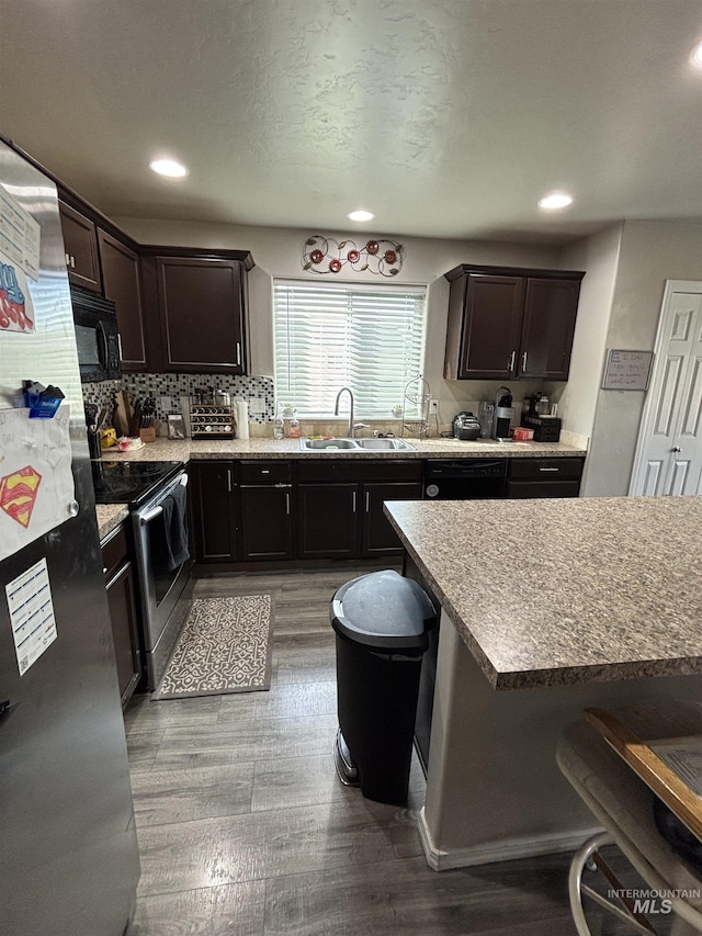 4618 Braeburn, Caldwell, ID 83607 - kitchen with black microwave, electric range, a sink, and wood finished floors