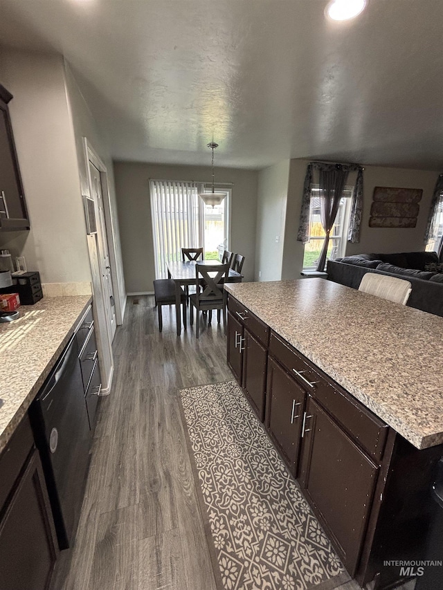 4618 Braeburn, Caldwell, ID 83607 - kitchen with dark brown cabinets, dishwasher, light countertops, dark wood-style flooring, and open floor plan