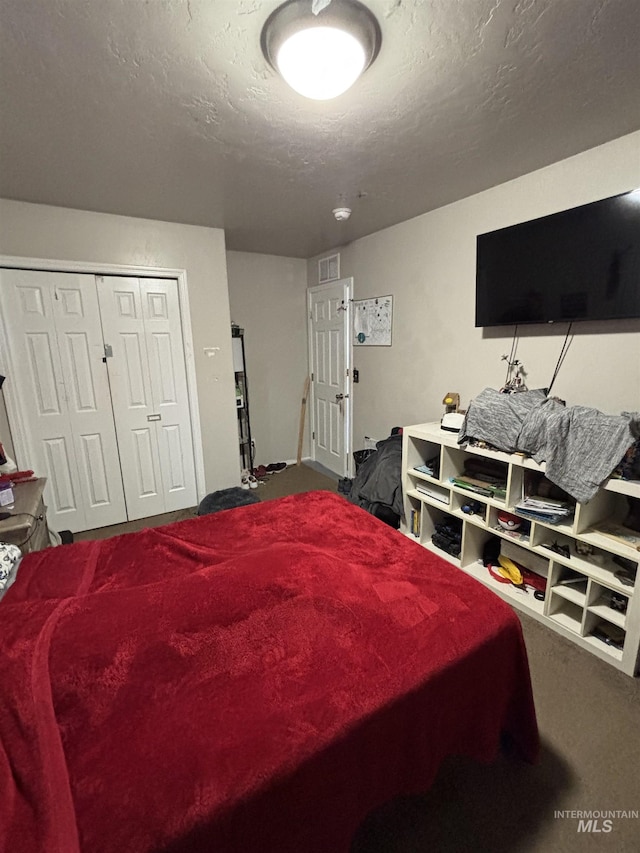 4618 Braeburn, Caldwell, ID 83607 - bedroom featuring a closet, dark colored carpet, visible vents, and a textured ceiling