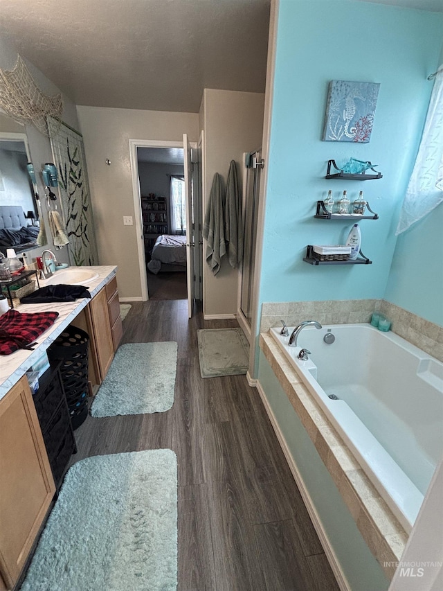 4618 Braeburn, Caldwell, ID 83607 - bathroom featuring a bath, wood finished floors, vanity, and connected bathroom