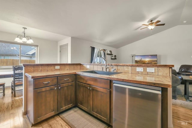 kitchen featuring dishwasher, plenty of natural light, open floor plan, and a sink