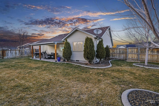 rear view of house featuring crawl space, a yard, a fenced backyard, and a patio area