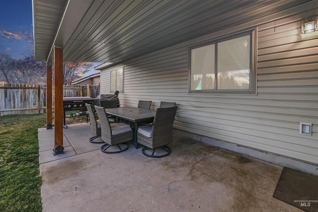 view of patio with outdoor dining space and fence