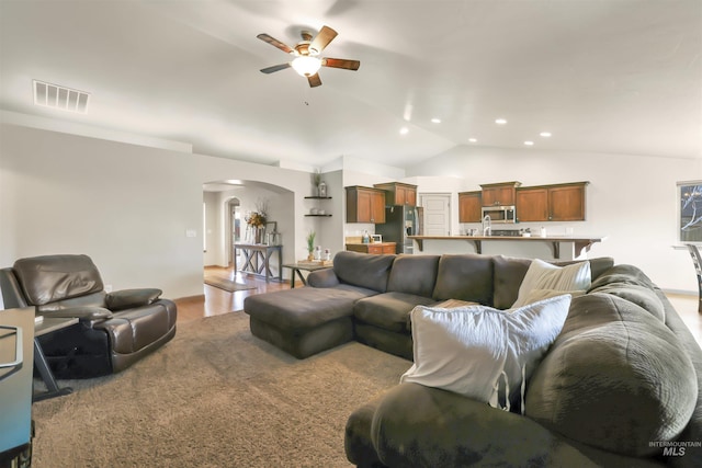 living room with visible vents, recessed lighting, arched walkways, ceiling fan, and vaulted ceiling