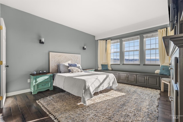 bedroom with dark hardwood / wood-style flooring