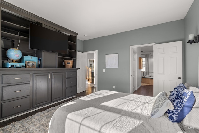 bedroom featuring dark wood-type flooring and connected bathroom