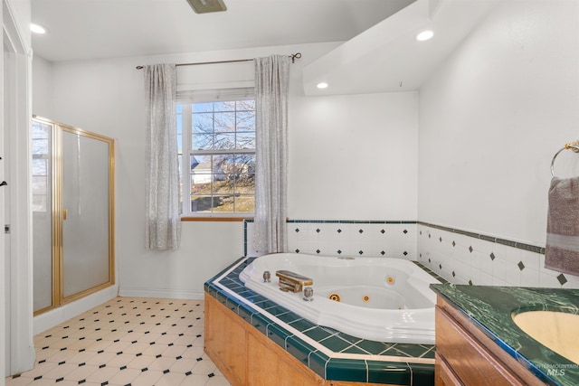 bathroom featuring vanity and separate shower and tub