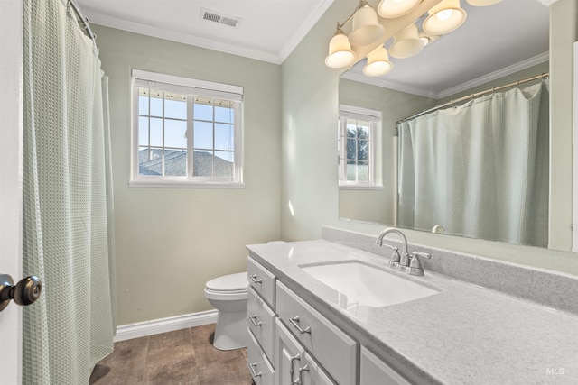 bathroom with a healthy amount of sunlight, toilet, vanity, and ornamental molding