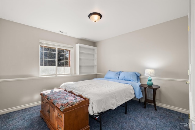 bedroom featuring dark colored carpet