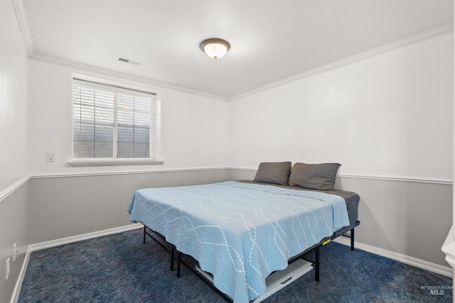 bedroom featuring crown molding and dark colored carpet