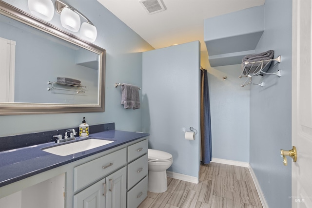 bathroom featuring toilet and vanity