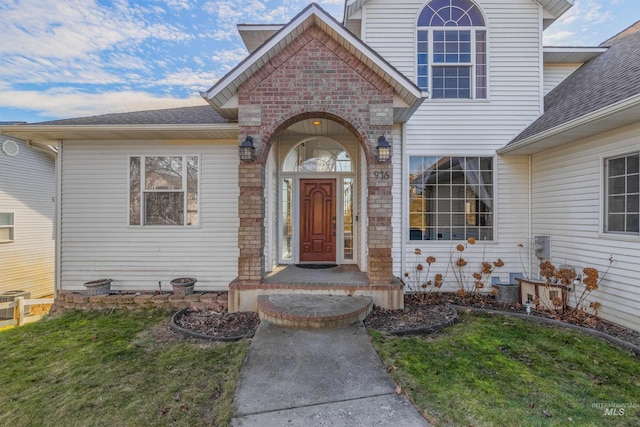 doorway to property with a yard