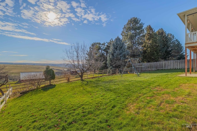 view of yard with a playground and a rural view