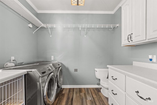 washroom featuring separate washer and dryer, dark hardwood / wood-style flooring, and ornamental molding