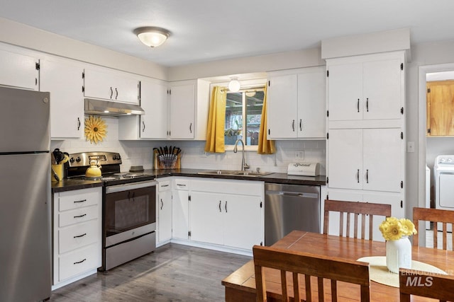 kitchen with sink, decorative backsplash, dark hardwood / wood-style flooring, white cabinetry, and stainless steel appliances