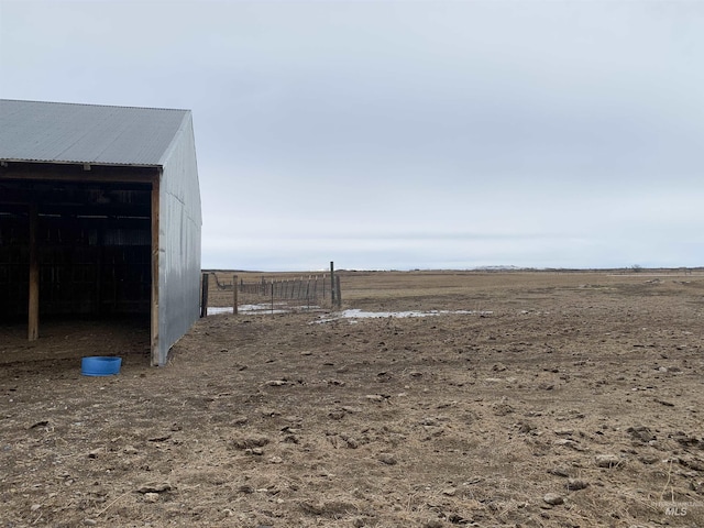 view of yard with an outbuilding and a rural view