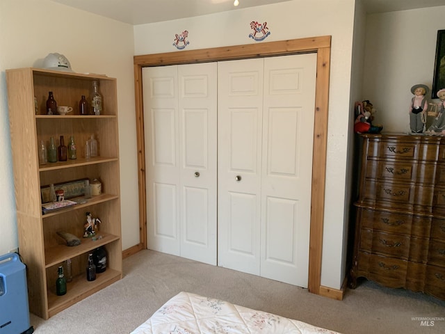 bedroom featuring light carpet and a closet