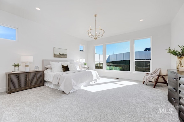 carpeted bedroom with recessed lighting, baseboards, and a chandelier