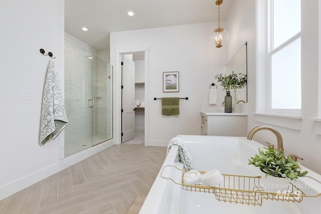 bathroom featuring a tub to relax in, recessed lighting, a shower stall, baseboards, and vanity