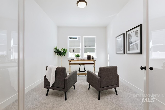 home office featuring baseboards and light carpet