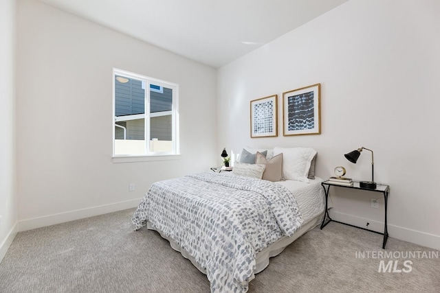 bedroom with baseboards and carpet flooring