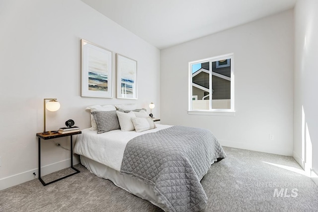 bedroom featuring baseboards and carpet