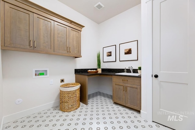 laundry room with visible vents, cabinet space, electric dryer hookup, washer hookup, and a sink