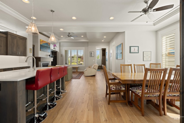 6178 N Bolsena Ln, Meridian, ID 83646 - dining space with a ceiling fan, ornamental molding, light wood finished floors, a tray ceiling, and recessed lighting