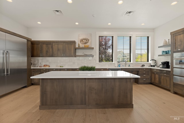 6178 N Bolsena Ln, Meridian, ID 83646 - kitchen with open shelves, stainless steel appliances, a kitchen island, light countertops, and recessed lighting