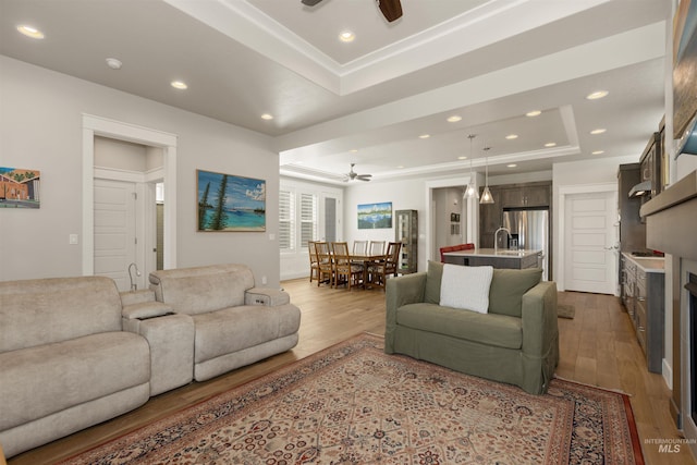 6178 N Bolsena Ln, Meridian, ID 83646 - living room featuring a ceiling fan, a raised ceiling, wood finished floors, and recessed lighting