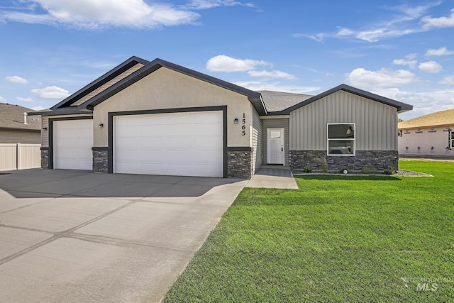 view of front facade with an attached garage, stone siding, concrete driveway, and a front yard