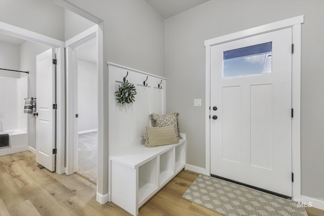 mudroom featuring light wood-type flooring and baseboards