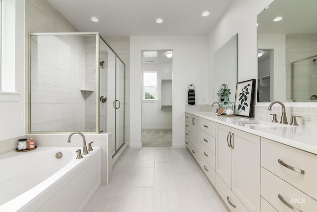 2005 N Spring Creek Ave, Middleton, ID 83644 - bathroom with double vanity, a stall shower, a garden tub, baseboards, and recessed lighting